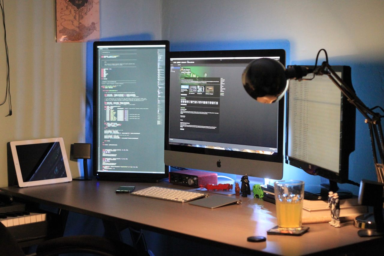 A clean workspace featuring computer electronics, debugging modules, and a calibrated testing screen